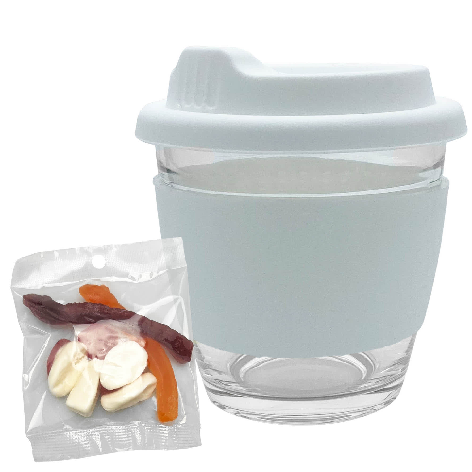 A glass coffee cup with a light blue silicone sleeve, accompanied by a pack of mixed jelly lollies in various colours.