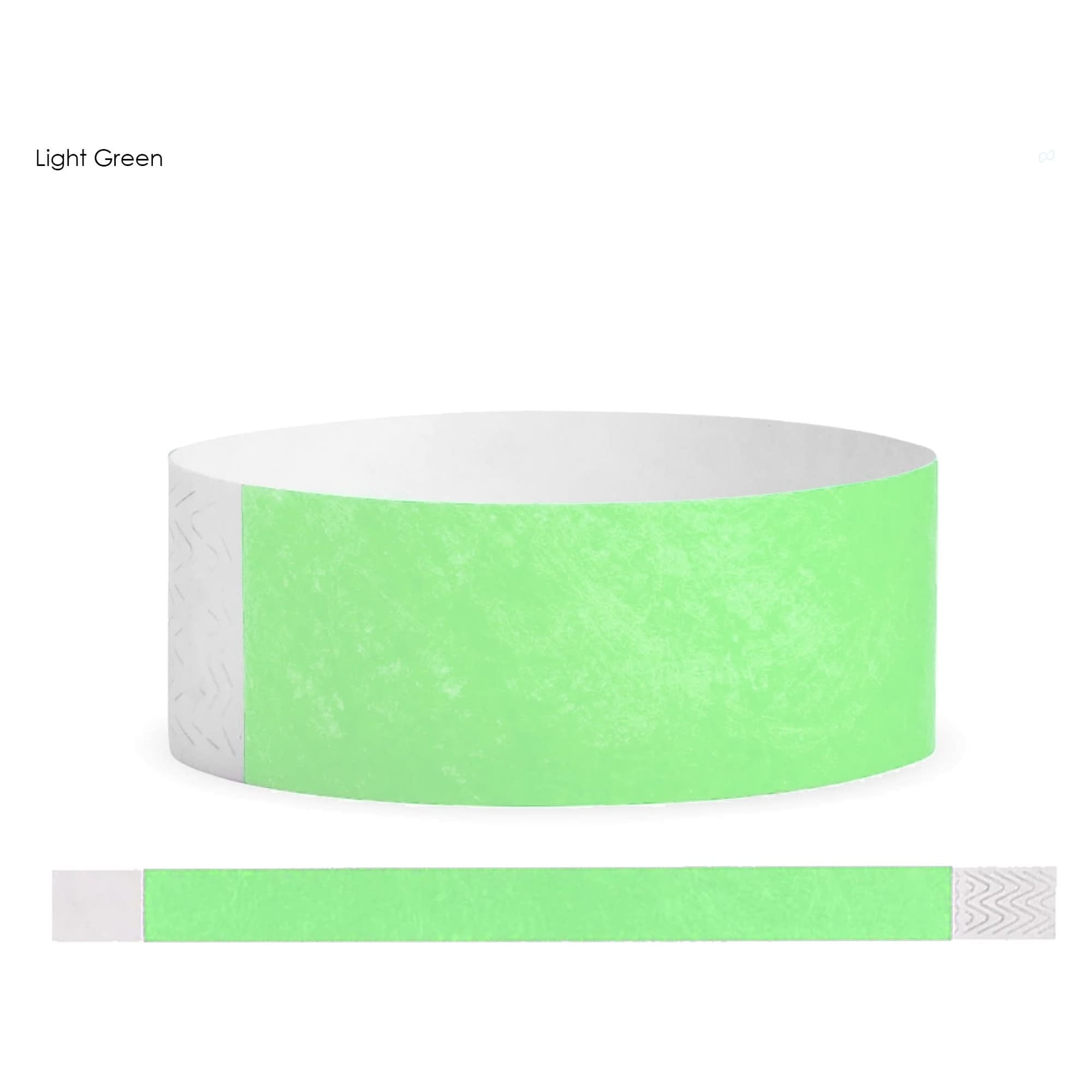 A light green Tyvek adult wristband with a decorative white end. Features a logo or branding.