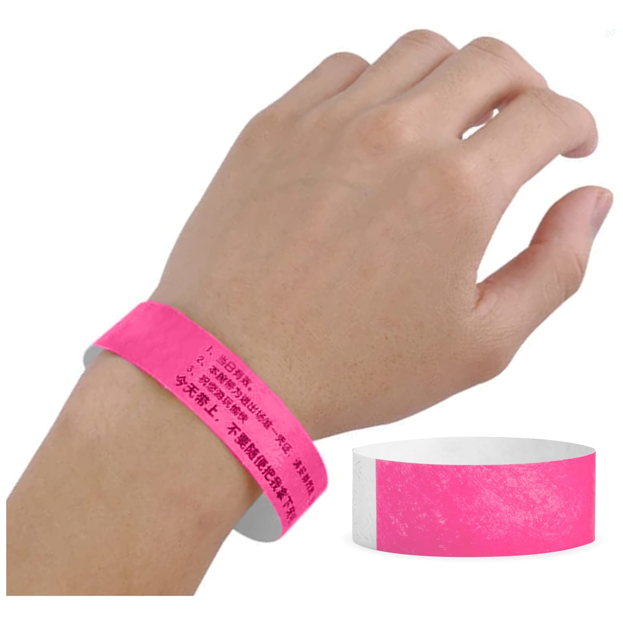 A pink Tyvek wristband worn on a hand, featuring a textured surface and a logo.