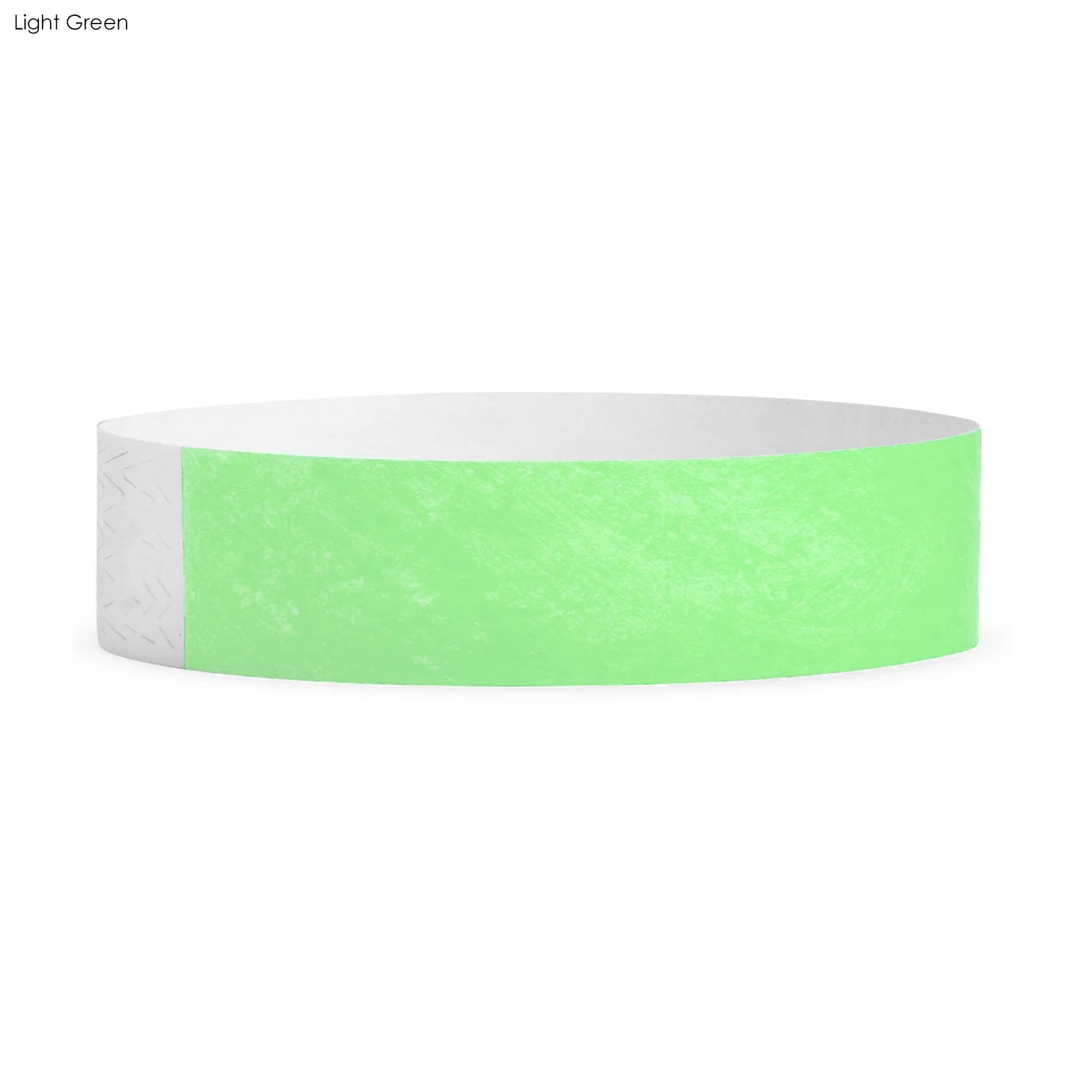 A light green Tyvek wristband with a smooth texture, featuring a logo. Suitable for events and exhibitions.