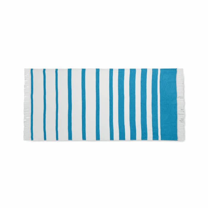 A striped beach towel featuring alternating blue and white stripes with fringe detailing on the ends.