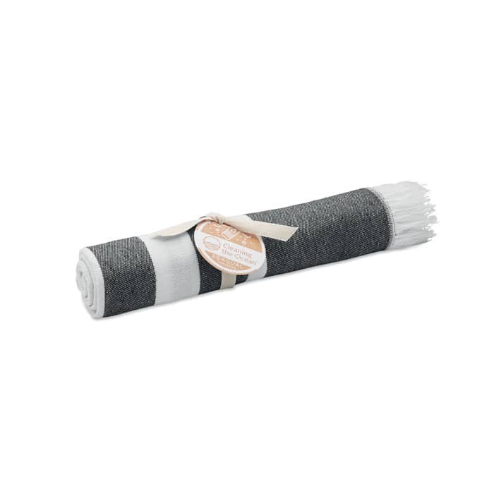 A rolled towel in grey and white, tied with a ribbon and featuring a circular tag.