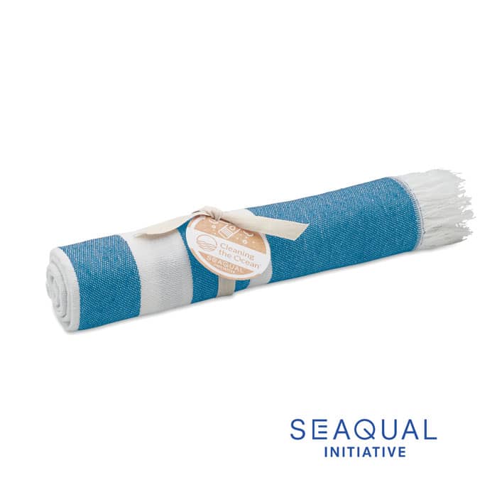 A rolled beach towel in shades of blue and white, tied with a ribbon and featuring a logo.