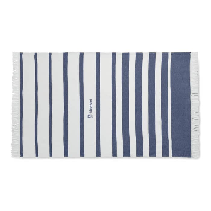 A striped beach towel featuring blue and white colours with fringed edges and a logo.