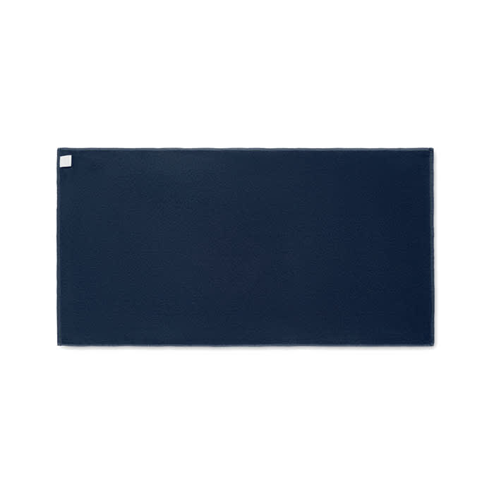 A rectangular navy blue mat with a small logo in one corner.