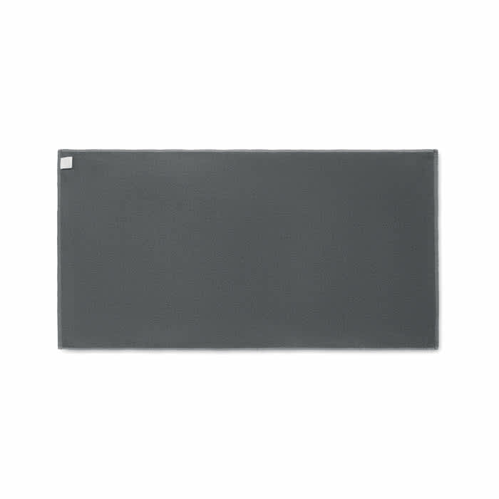 A grey rectangular mat with a subtle texture and a small logo in one corner.