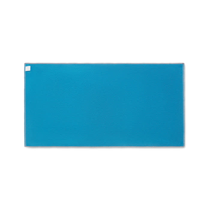 A large rectangular product in a vibrant turquoise colour with a textured surface and a white label in one corner.