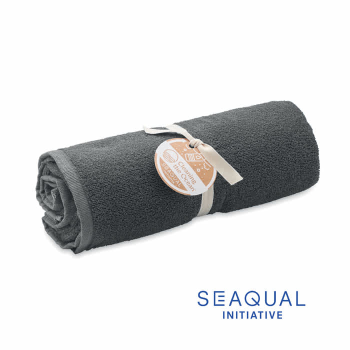 A rolled grey towel with a tag, featuring a logo of the Seaqual Initiative.