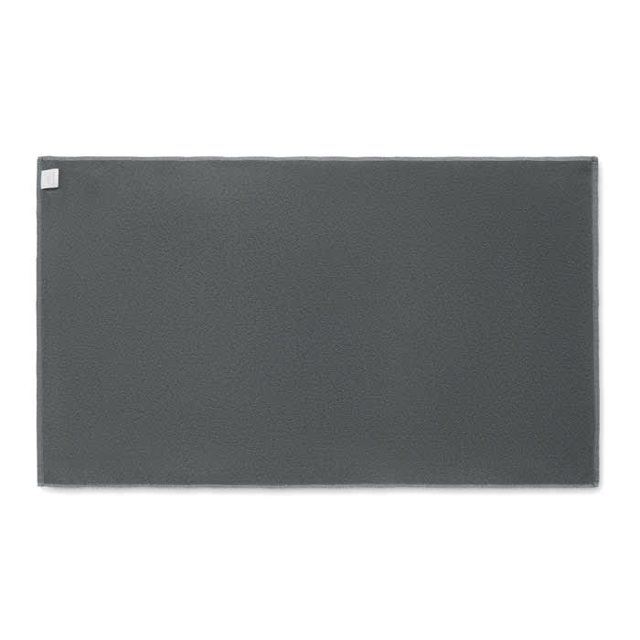 A grey mat displayed flat, featuring a textured surface and a small logo in the corner.