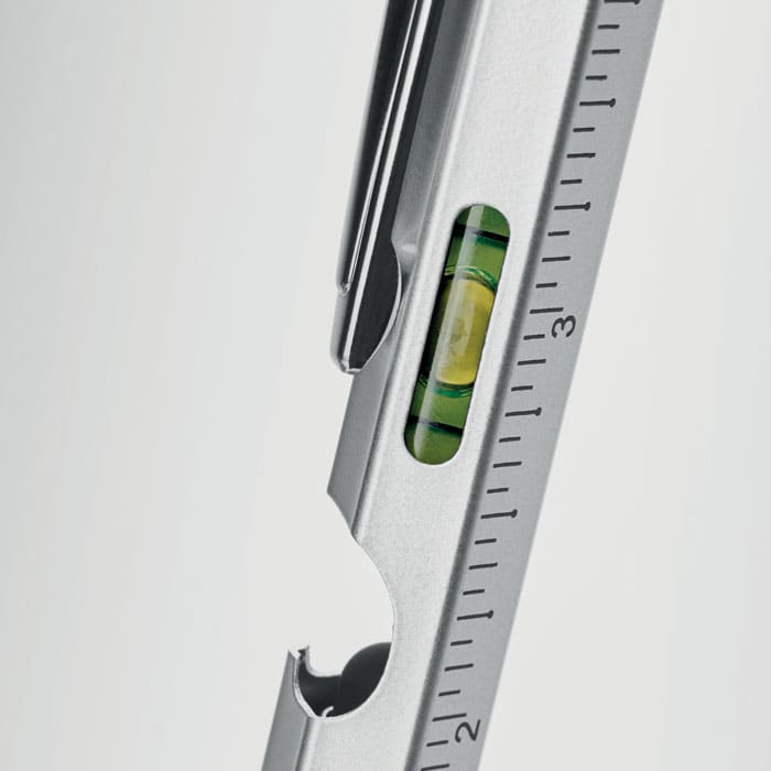 A measuring tool in silver with a built-in level, marked with measurement increments. It has a logo on the side.