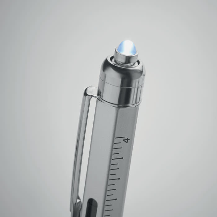 A silver pen with a transparent blue tip, featuring measurement markings along the barrel and a clip.