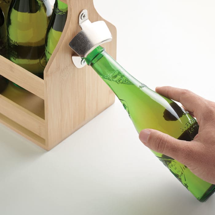 A green drink bottle being held next to a wooden crate containing more green bottles. The crate has a simple design.