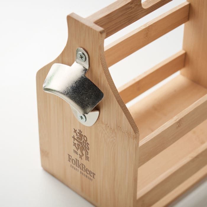 A bamboo carrier with a silver bottle opener attached, featuring a logo on the front.