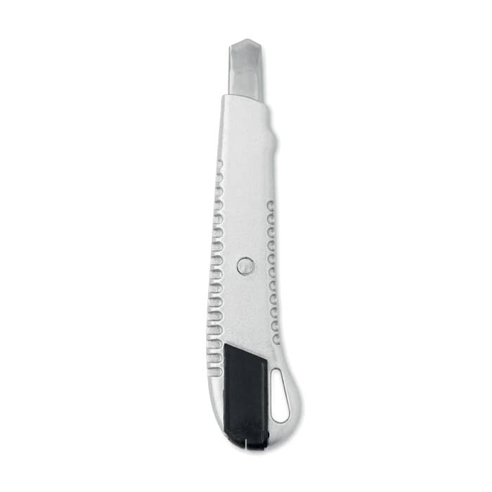 A utility knife with a silver body, featuring a retractable blade and a black rubber grip.