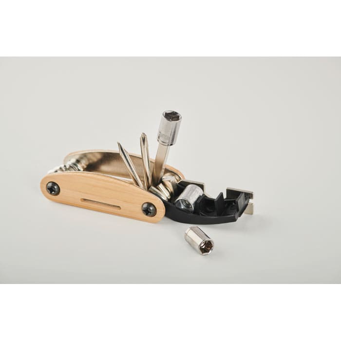 A multi-tool with a wooden handle and metallic tools, featuring various attachments and a small socket.
