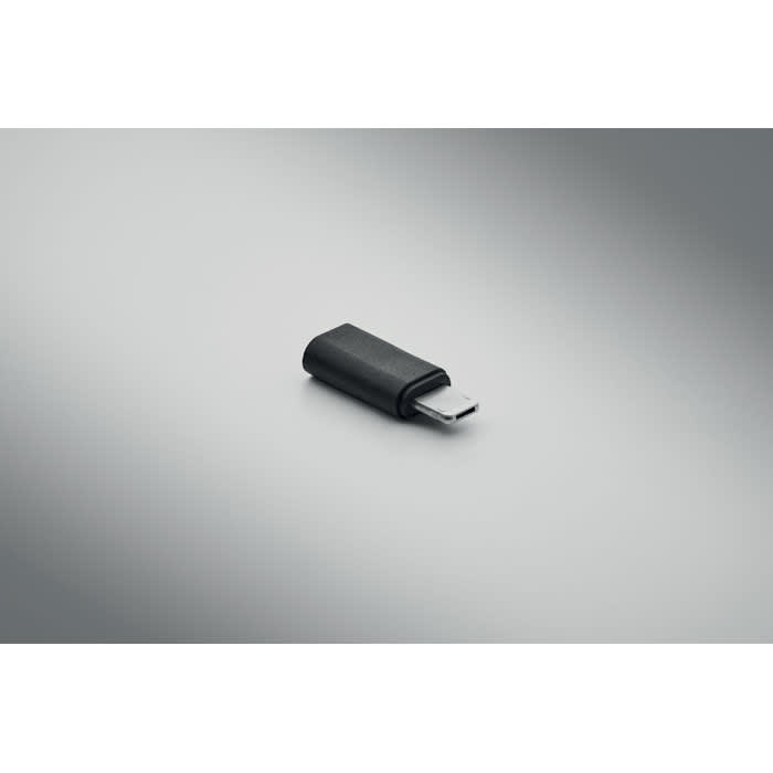 A black USB flash drive with a sleek design on a grey background. It features a simple logo.