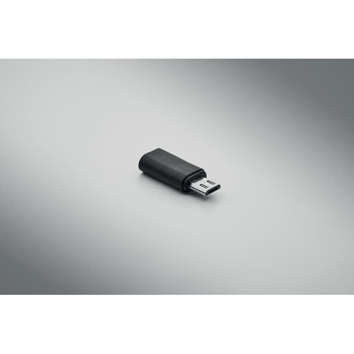 A USB drive in a black casing, featuring a small removable connector. The background is a smooth, grey gradient.
