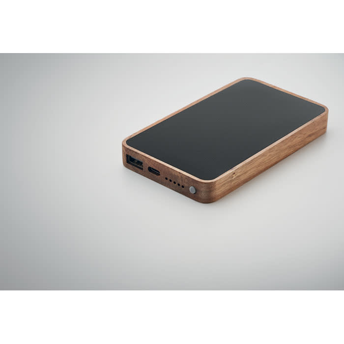 A power bank with a wooden finish and a black top, featuring USB ports.