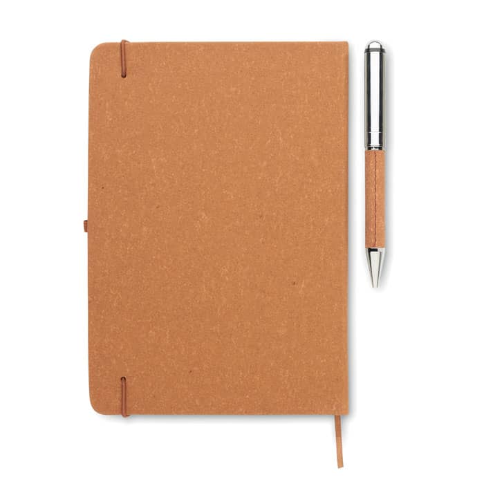 A brown notebook with a pen beside it, featuring a textured cover and a simple elastic closure.