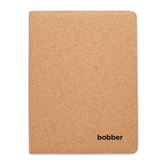 A cork-covered notebook with rounded corners, featuring a small logo in the bottom corner.