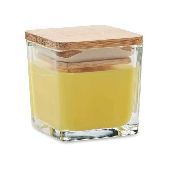 A square glass container with a bamboo lid, filled with a yellow substance.