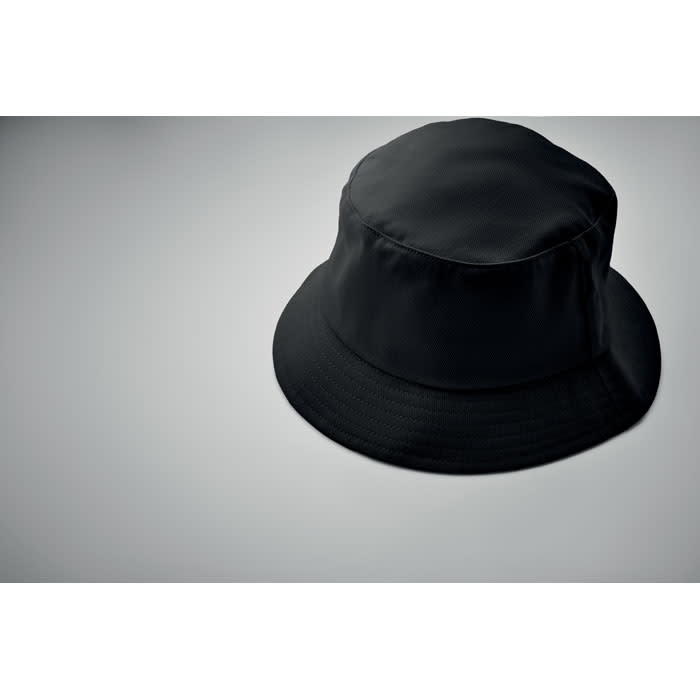 A black bucket hat on a grey background. The hat has a simple design and a soft texture.
