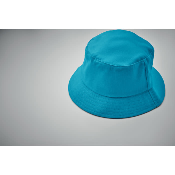 A bucket hat in bright blue with a wide brim, placed on a grey background.