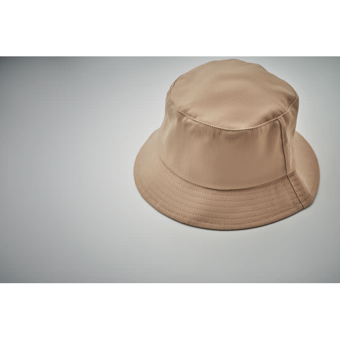 A beige bucket hat with a wide brim, featuring a simple design and a smooth texture.