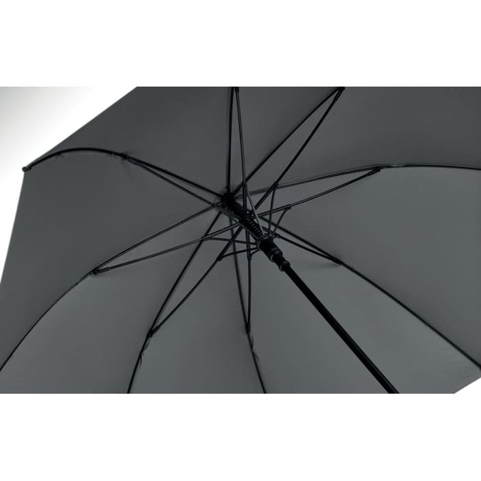 An umbrella with a black exterior and a sturdy handle, showcasing its internal framework and ribs.