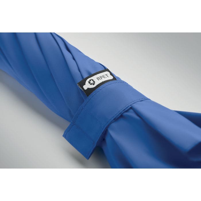 A blue fabric product with a black tag featuring a logo. The fabric appears smooth and neatly folded.