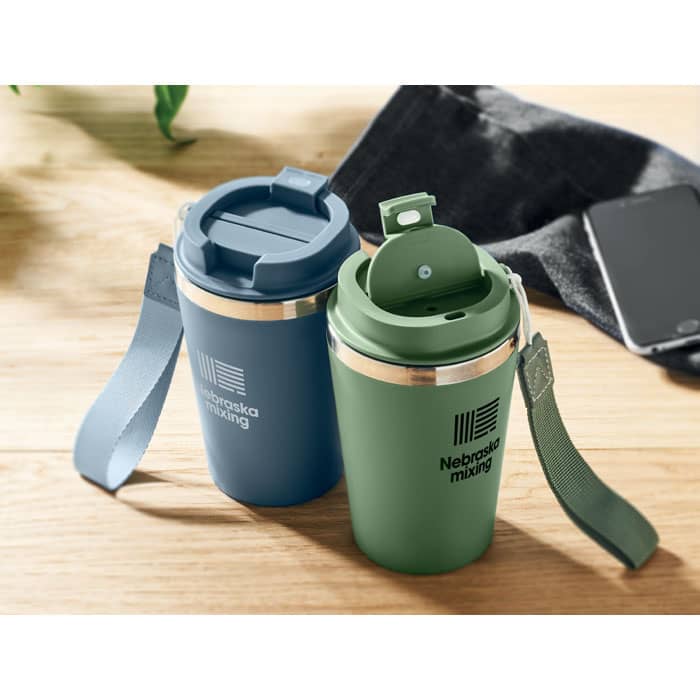A drink bottle duo featuring a blue and a green cup with a metallic band and looped lids, resting on a wooden surface.
