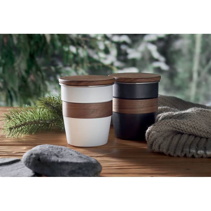 A drink bottle set featuring two cups, one white and one black, both with wooden lids and decorative bands.
