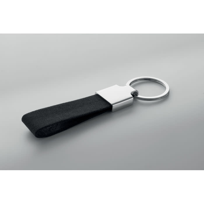 A keyring with a black leather strap and a silver metal attachment. It has a simple and sleek design.