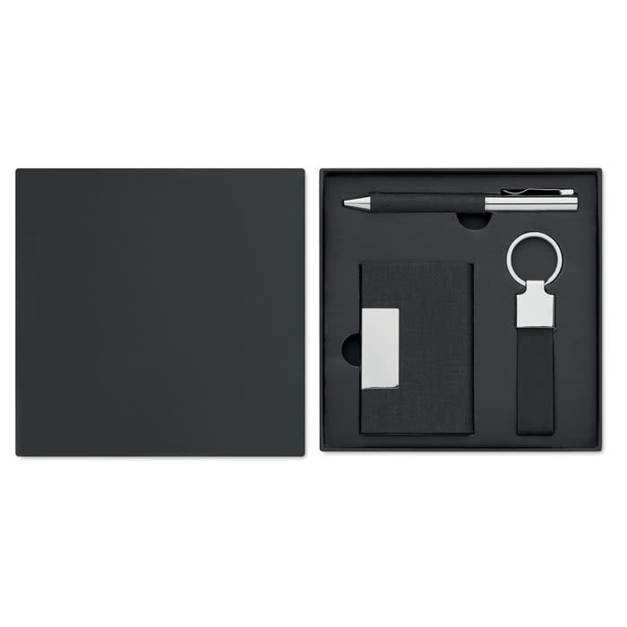 A black gift box containing a pen, a cardholder, and a keyring. The items are sleek and modern in design.