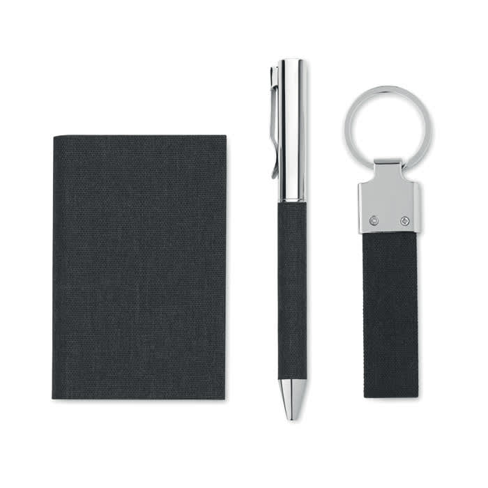 A black notebook, silver pen, and black keyring. The items feature a sleek, modern design.