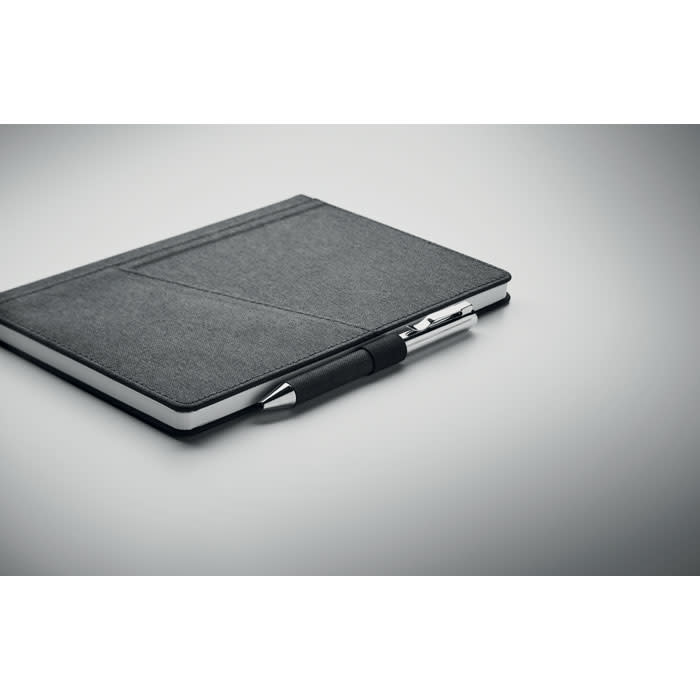 A black notebook with a pen attached, featuring a textured cover and a sleek design.