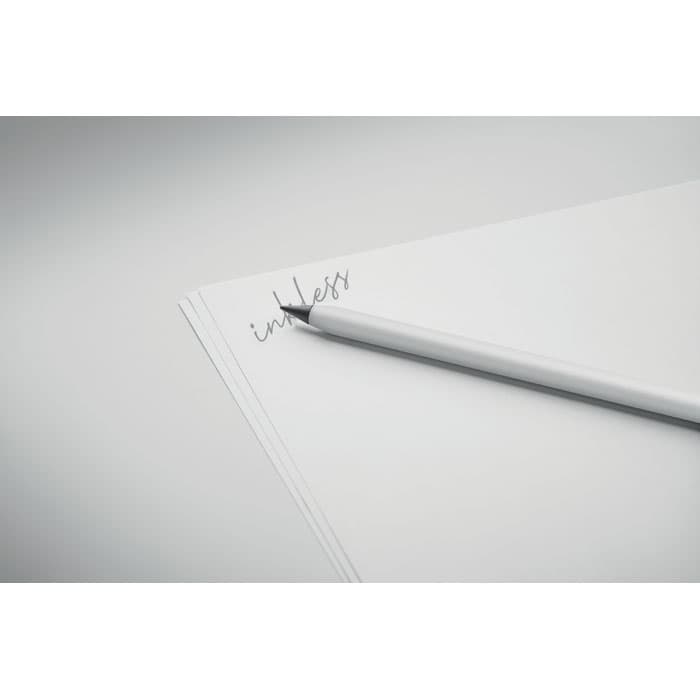 A sleek white pen resting on blank sheets of paper, with faint writing visible on the page.