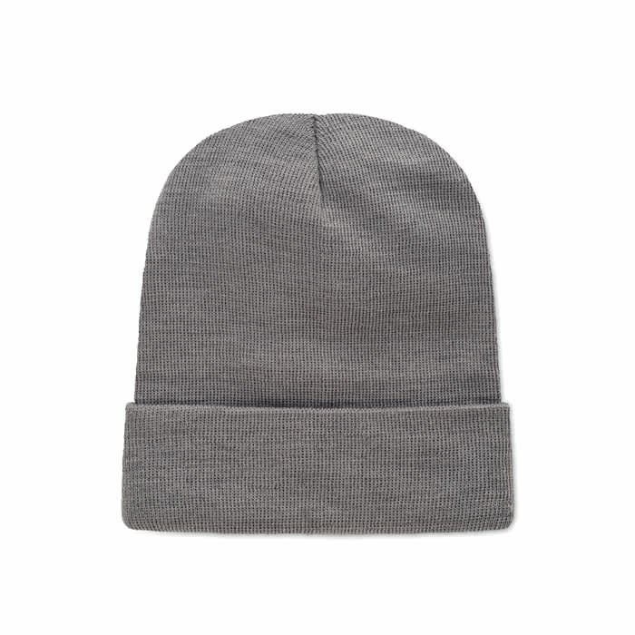 A grey knitted beanie featuring a folded cuff. The texture is ribbed and the design is simple.