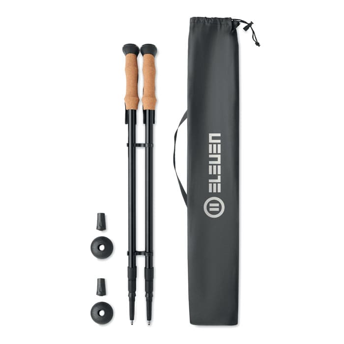 A pair of trekking poles with cork handles, tips, and a carrying bag in black.