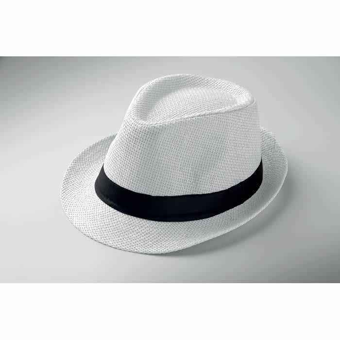A white straw fedora hat with a black band resting on a neutral background.