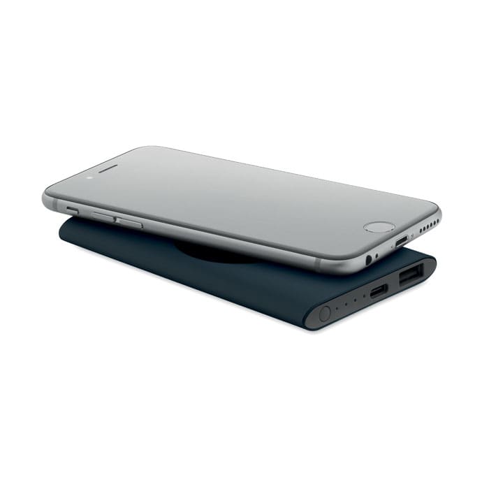 A sleek black power bank with a silver smartphone resting on top, featuring USB ports and indicator lights.