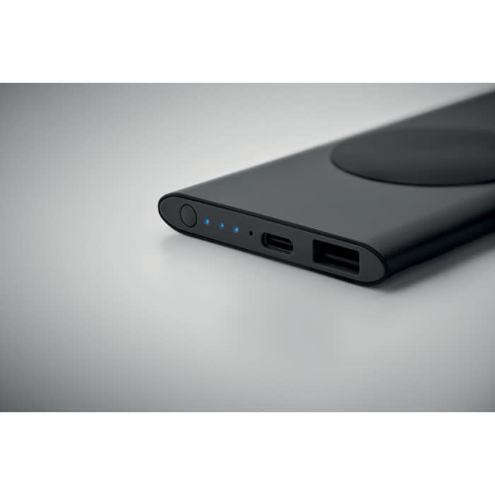 A power bank in sleek black, featuring charging ports and LED indicators. It has a smooth, modern design.