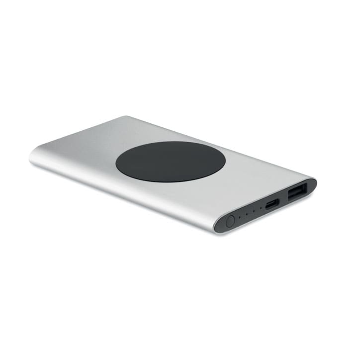 A power bank with a sleek silver exterior and a black circular charging area, featuring USB ports and indicator lights.