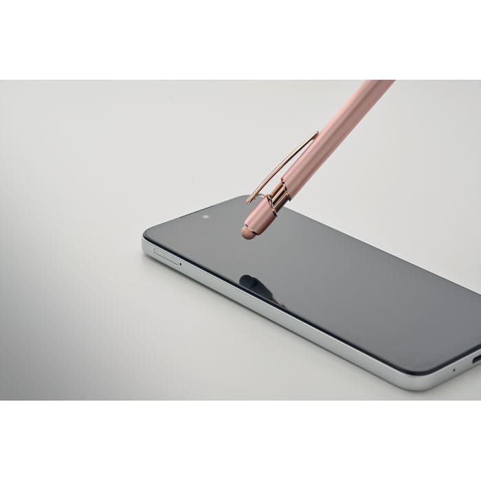 A pink pen with a gold clip positioned above a sleek black smartphone on a grey background.