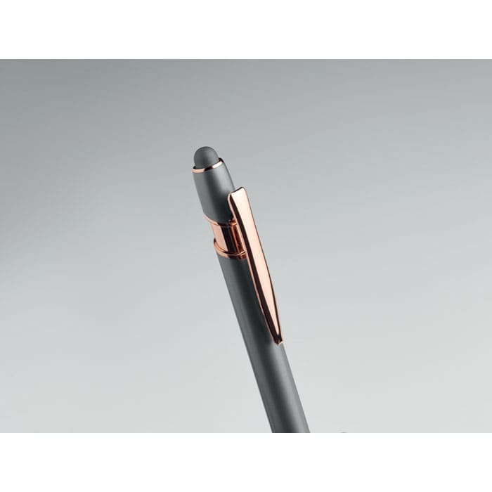 A grey pen with a rose gold clip and a stylus tip, featuring a sleek design.