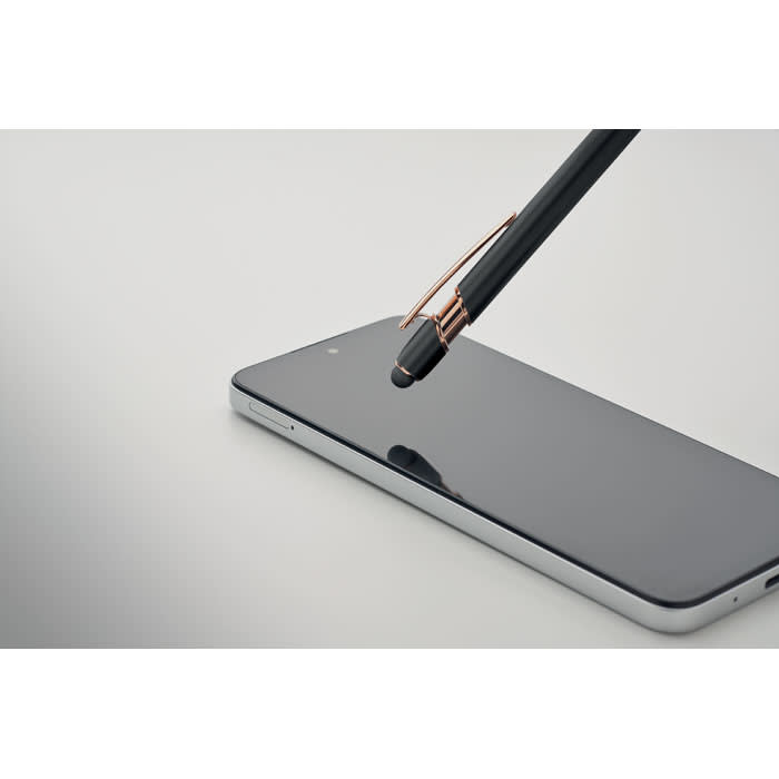 A black stylus pen with a rose gold clip is poised above a sleek, dark smartphone screen.