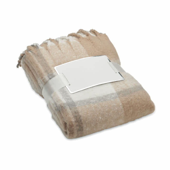 A folded blanket in shades of beige and cream, neatly secured with a plain band.
