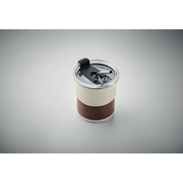 A drink bottle in cream and brown with a transparent lid and a dark straw, featuring a logo.
