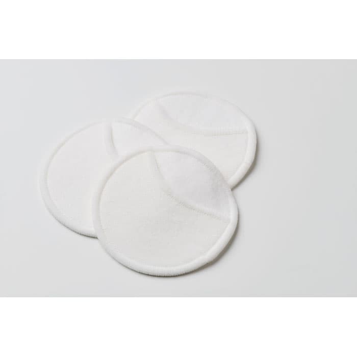Three round, white cotton pads are displayed on a light background.