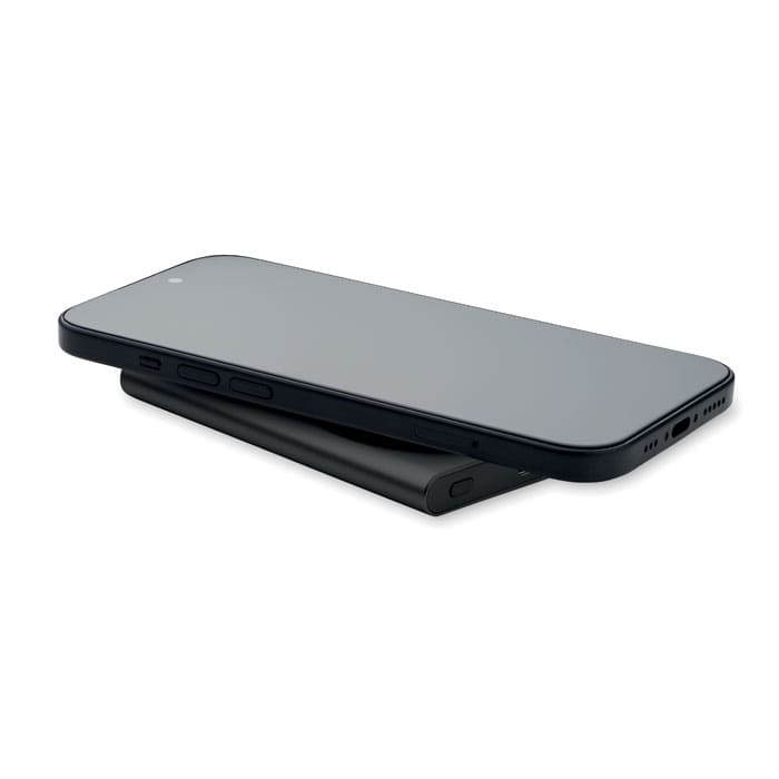 A black phone with a sleek design resting on a stand. The stand is also black and minimalistic in style.